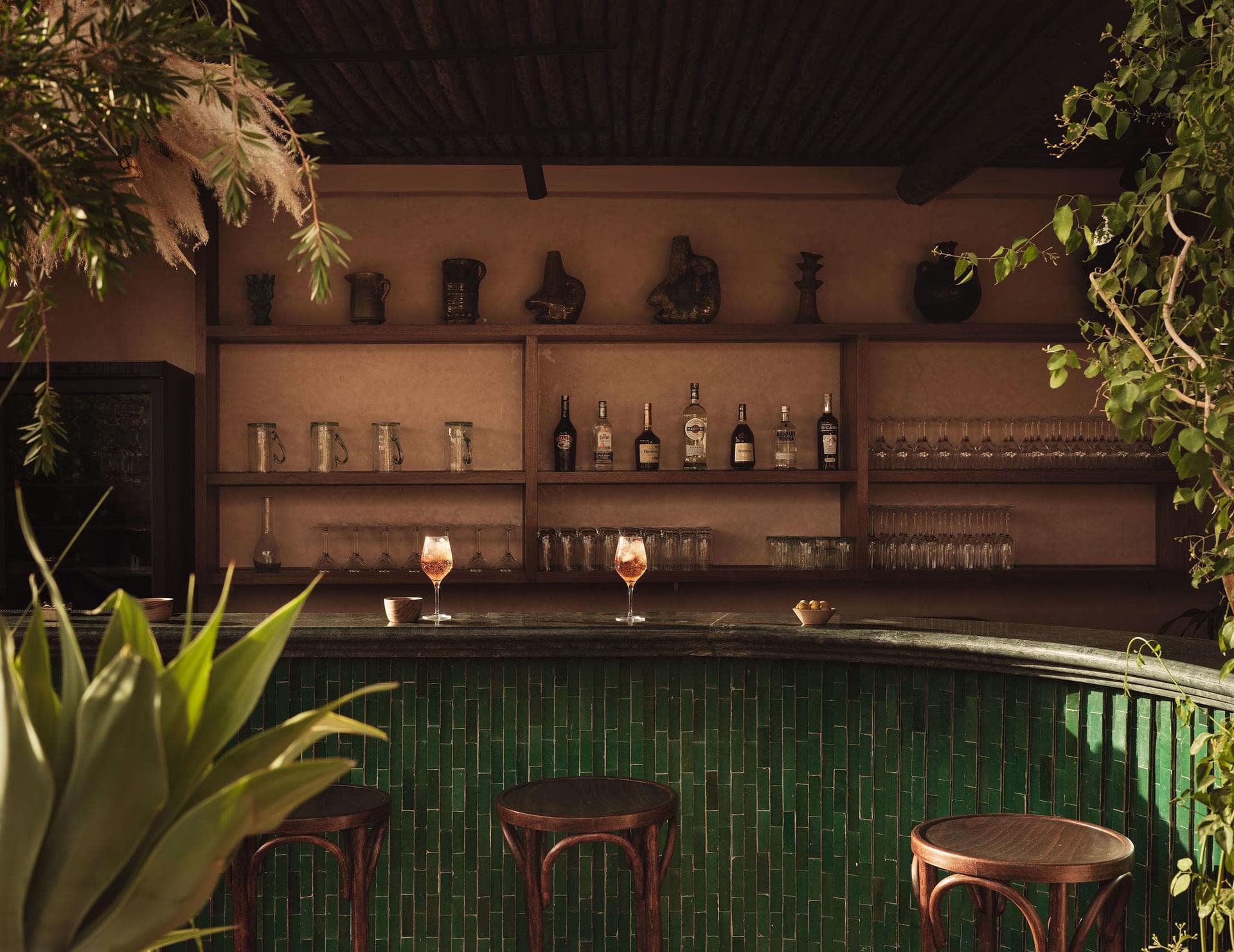 Bar counter with green tiles and bottles