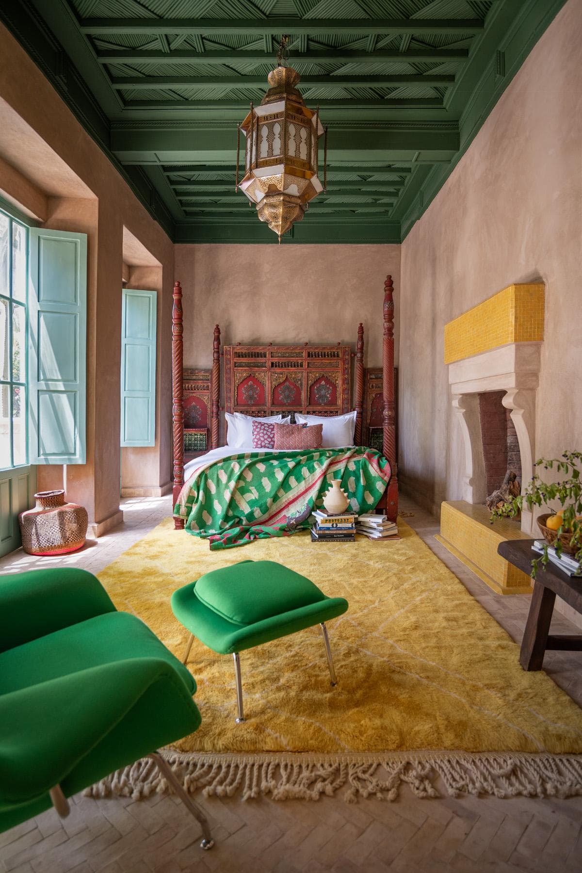 Green bedroom with carved bed
