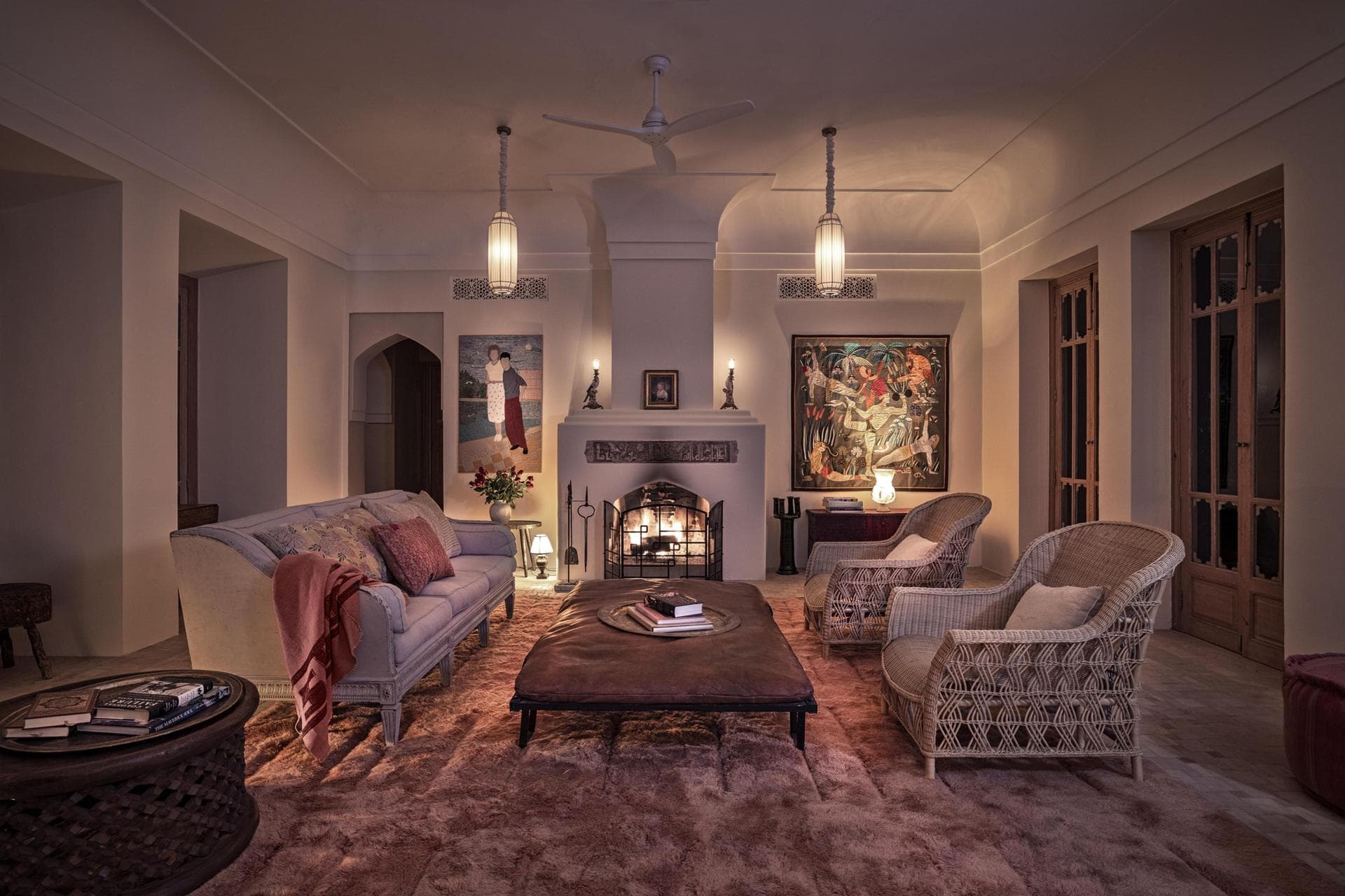 Evening lounge with fireplace and paintings